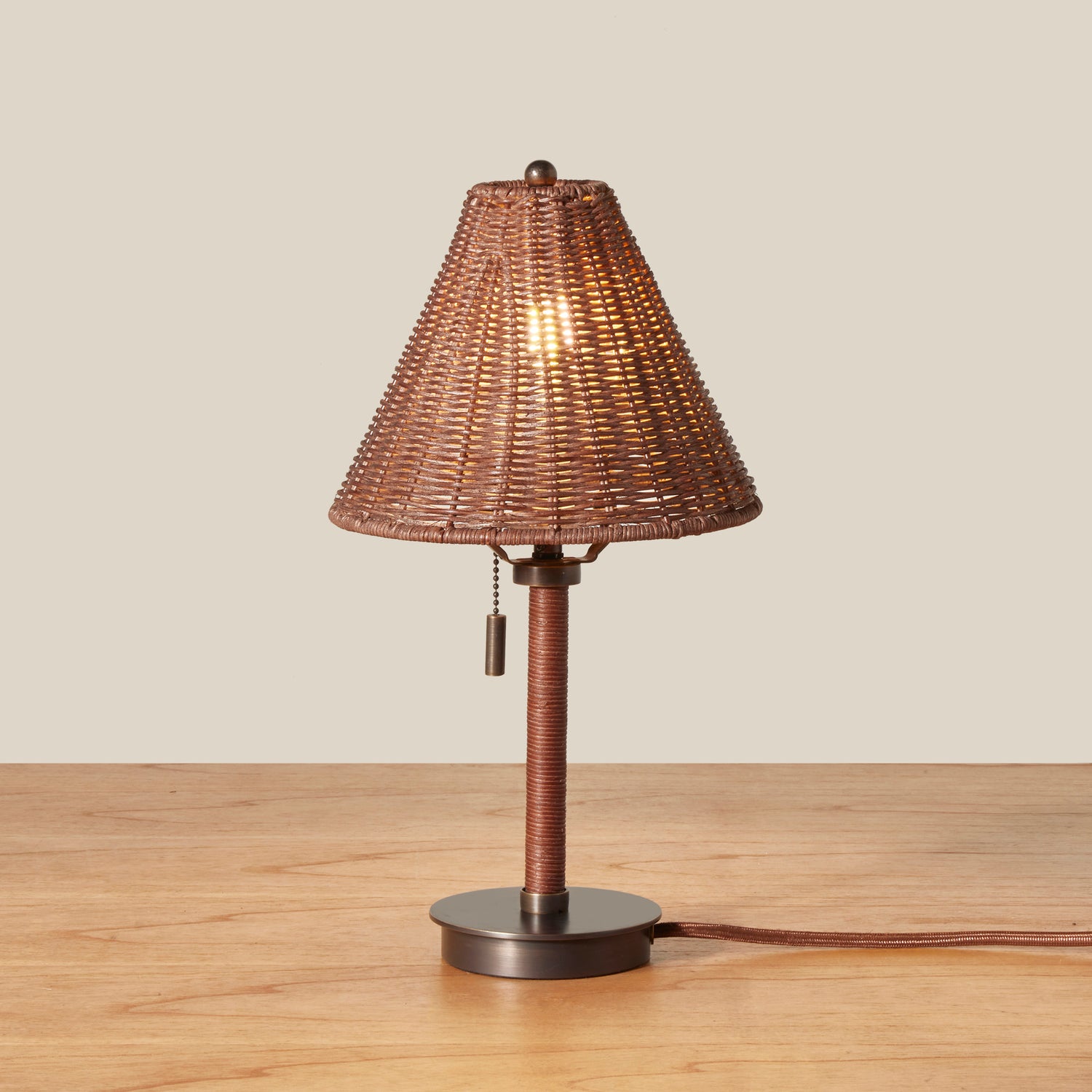 Table lamp with wicker shade on a wooden surface- Number 3