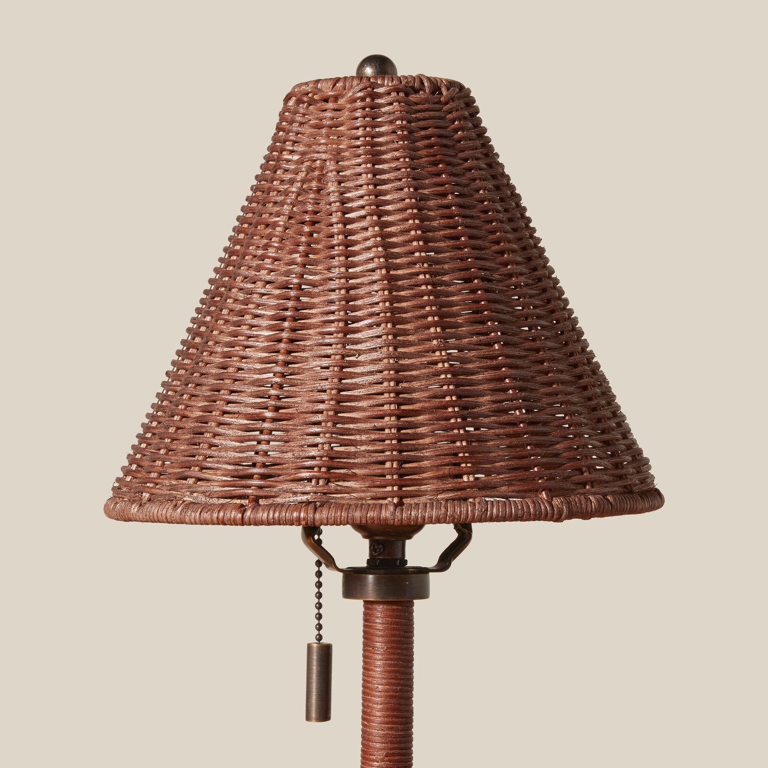 Wicker lampshade with pull chain on a beige background- Number 4