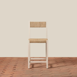 Wooden chair with woven seat and backrest on a wooden floor and beige wall - Number 15