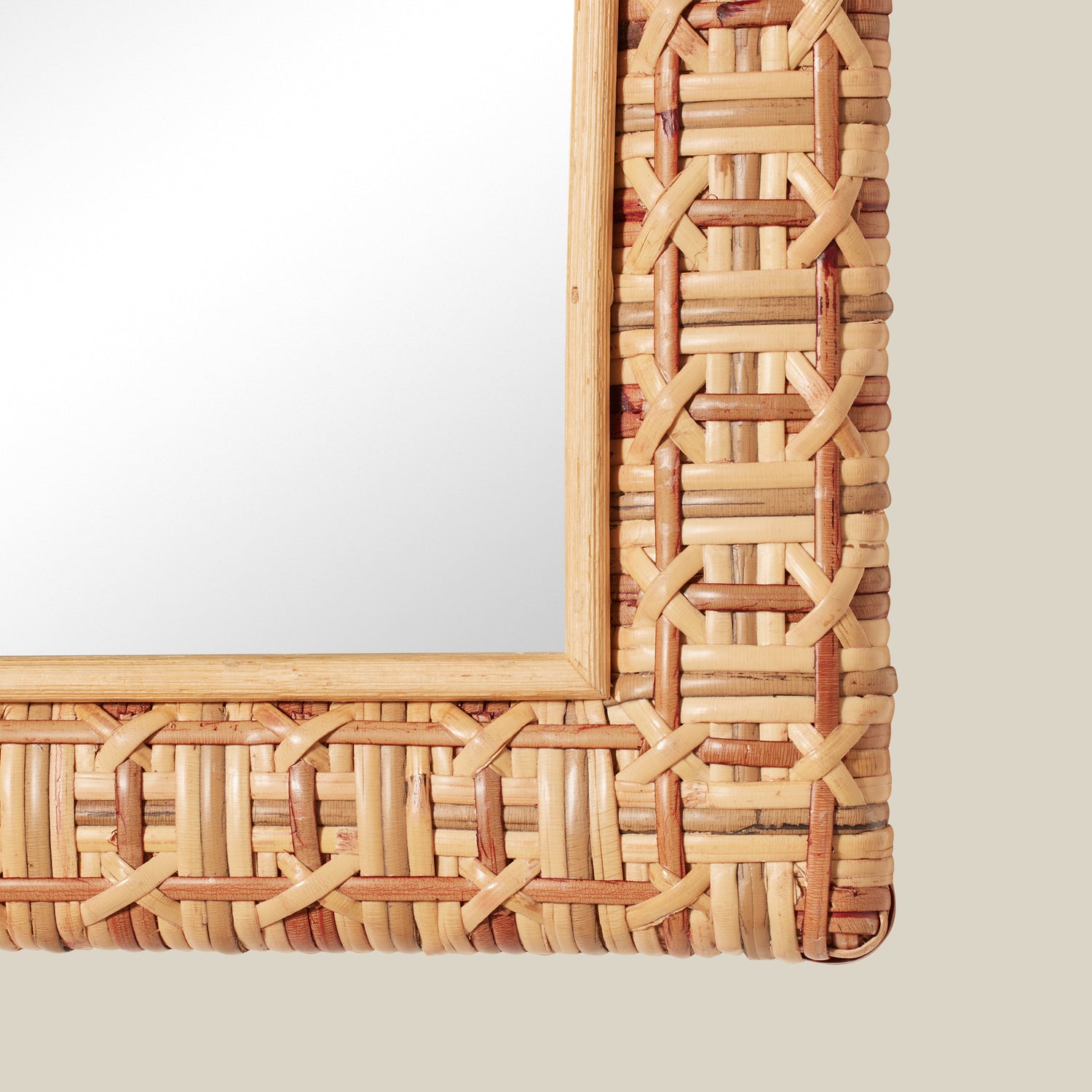 Woven rattan mirror on a plain background- Number 3