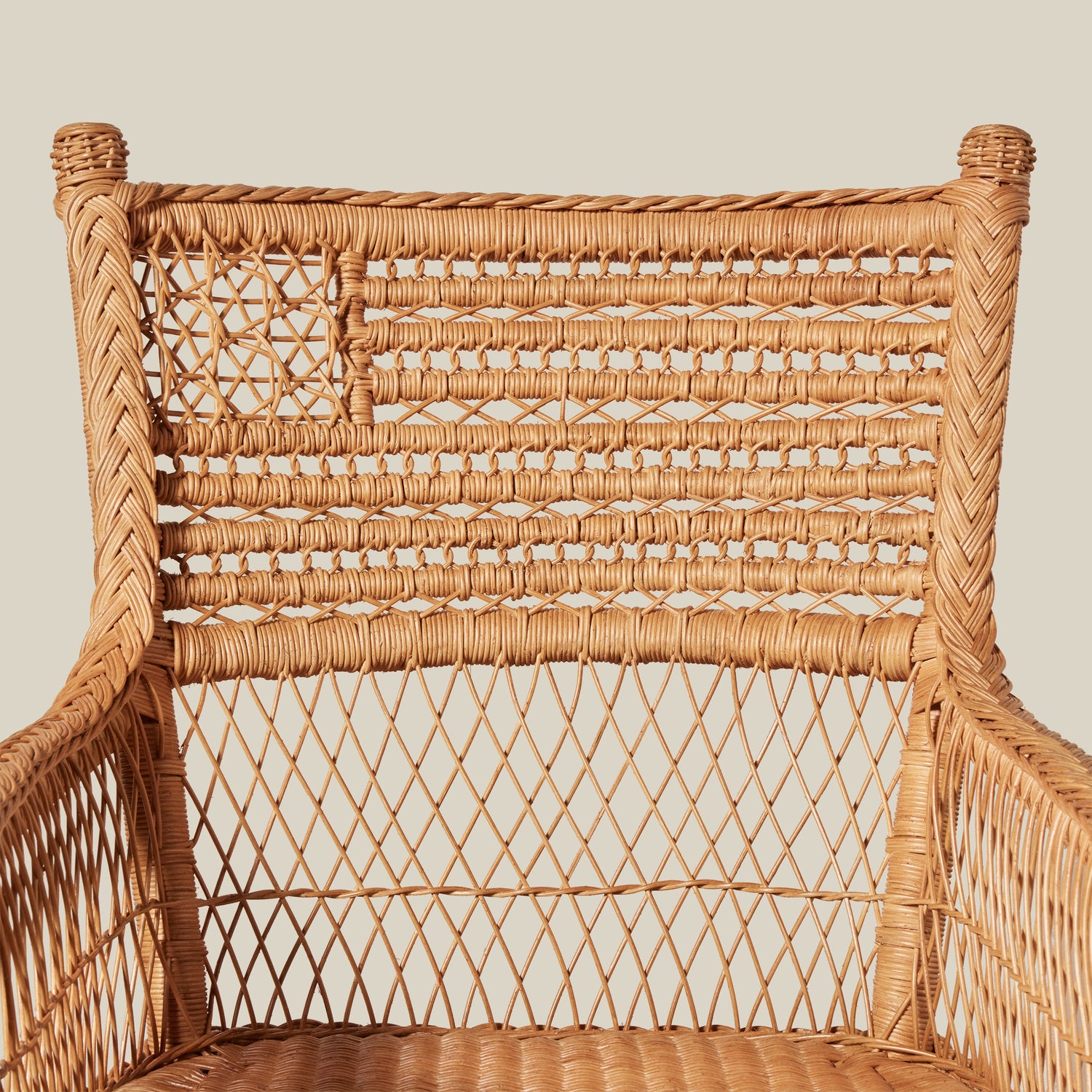 Woven wicker chair with intricate patterns on a neutral background- Number 5