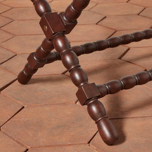 Close-up of a wooden tripod on a brick surface - Number 6