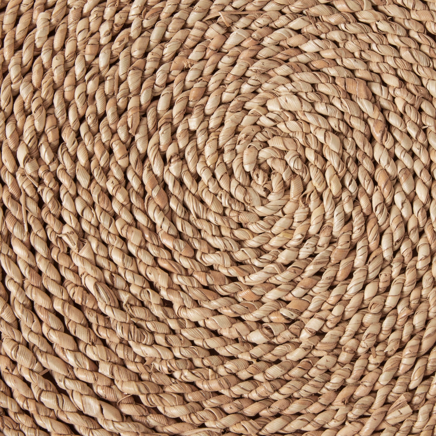 Close-up of a woven jute rug with a natural beige color.- Number 7