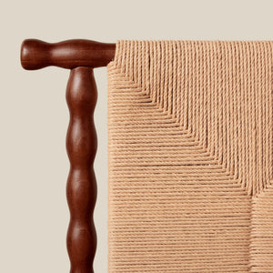 Close-up of a wooden chair leg and textured beige fabric - Number 6