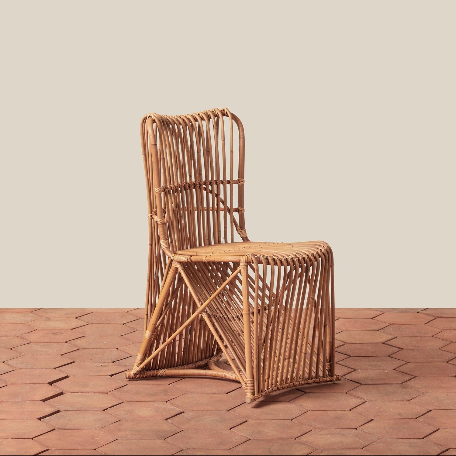 Woven chair on a wooden floor with a beige wall background- Number 1