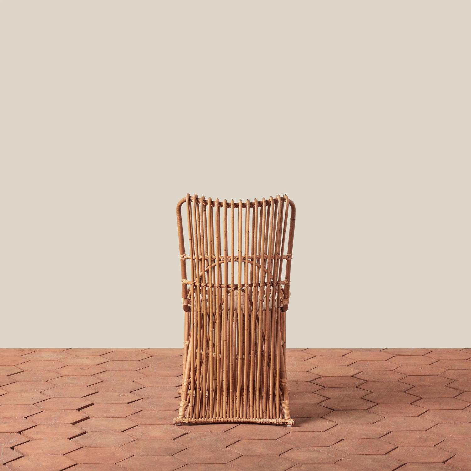 Woven rattan chair on a wooden floor with a beige wall background- Number 6