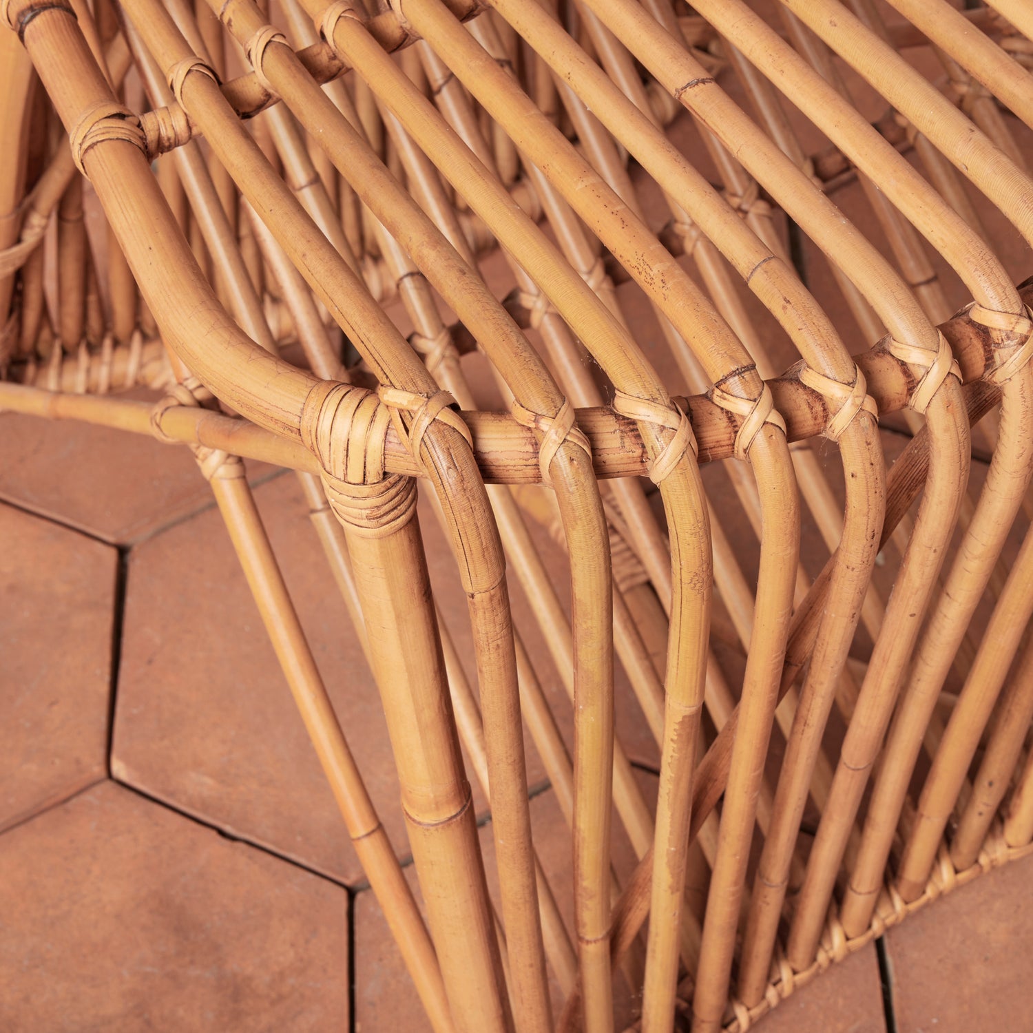 Close-up of a woven rattan chair on a wooden floor- Number 8