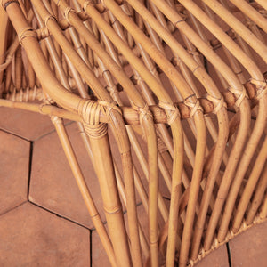 Close-up of a woven rattan chair on a wooden floor - Number 8