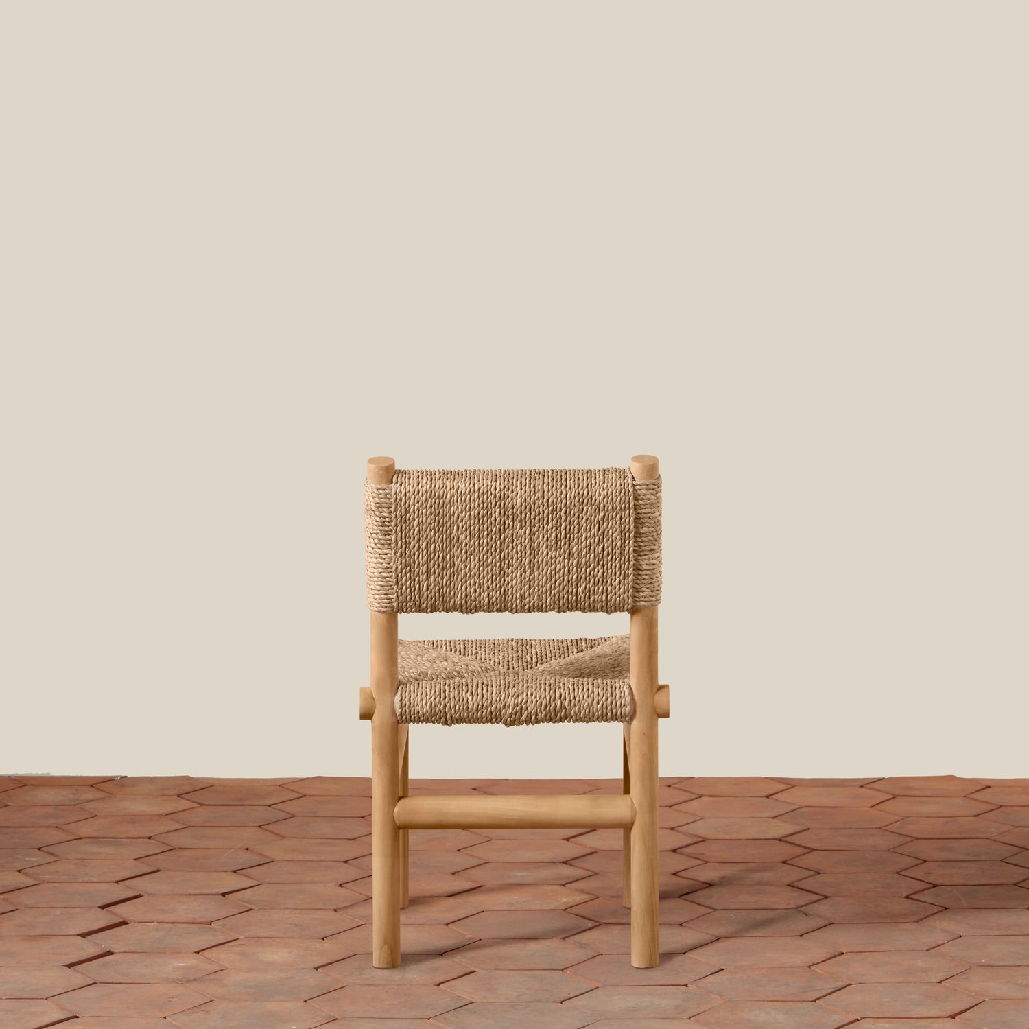Wooden chair with woven seat on a wooden floor and beige wall background- Number 7