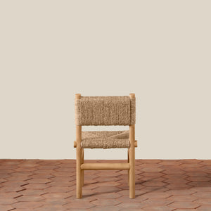 Wooden chair with woven seat on a wooden floor and beige wall background - Number 7