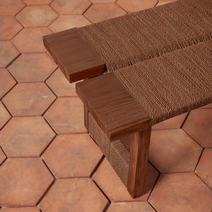 Brown woven bench on a hexagonal terracotta tile floor - Number 10