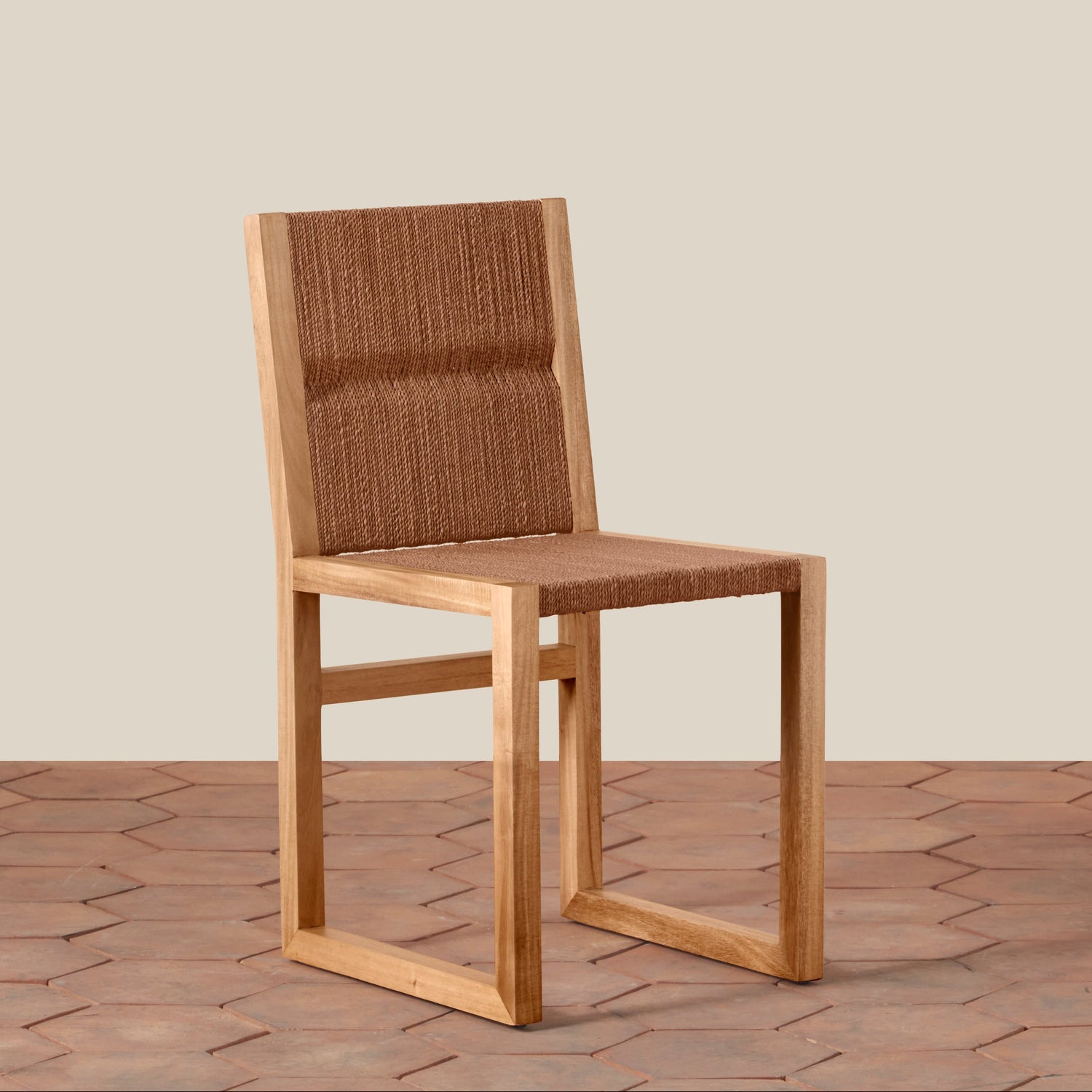 Wooden chair with woven backrest on a wooden floor and beige wall background- Number 1
