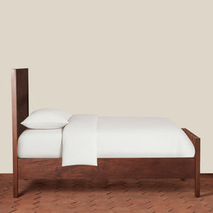 Wooden bed with white bedding on a beige background - Number 8