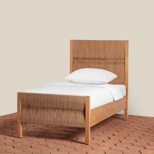 Wooden bed with white bedding on a wooden floor and beige wall background - Number 1