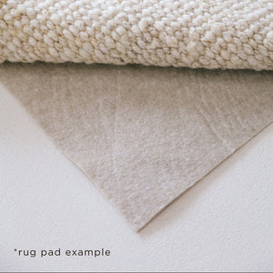 Close-up of a beige rug pad on a white surface - Number 6