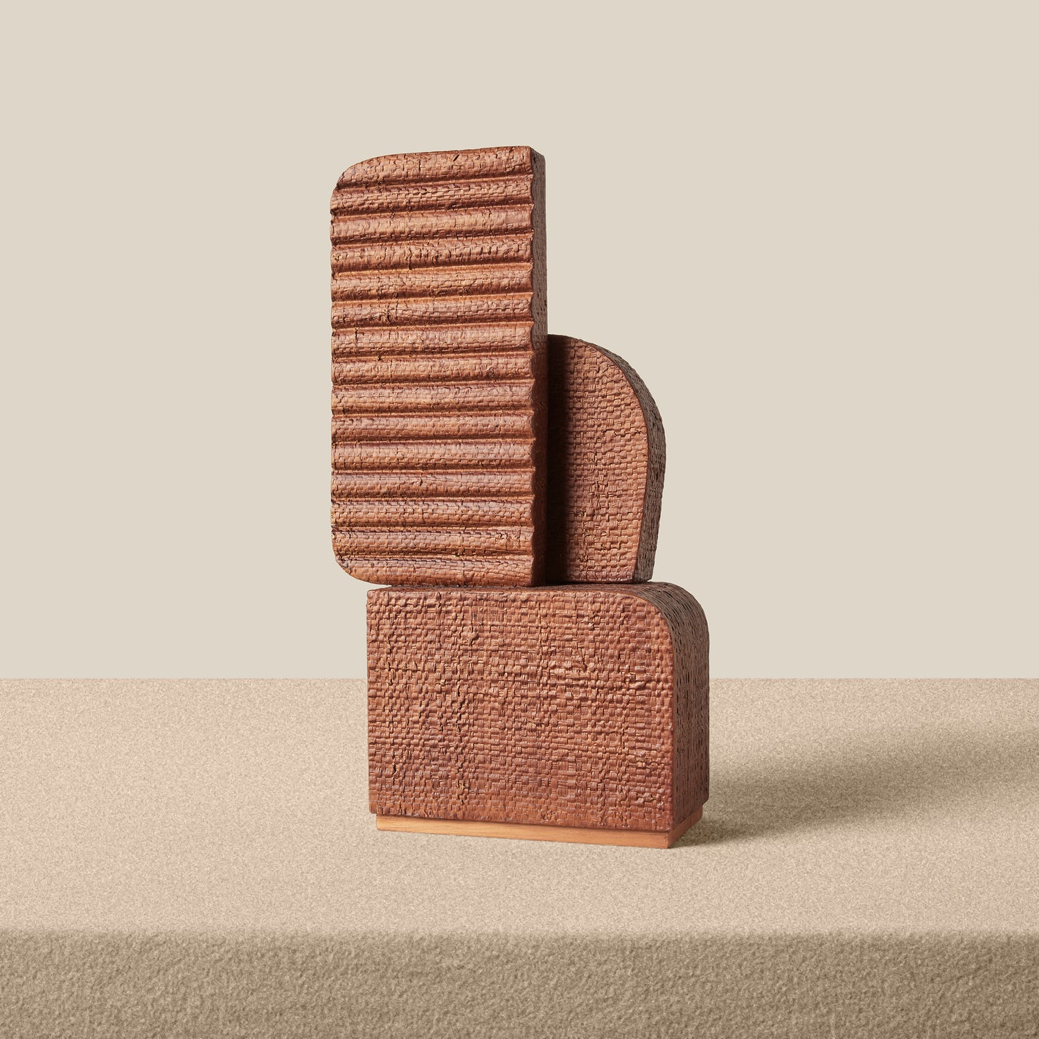 Textured brown sculpture on a beige background- Number 2