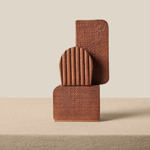 A brown textured sculpture on a beige surface - Number 1