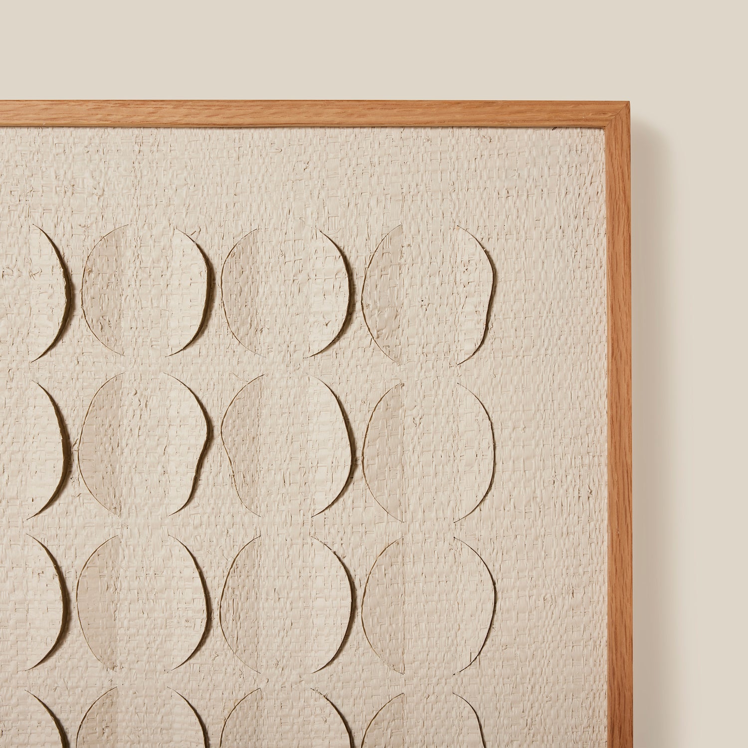 Framed artwork with embossed circular patterns on a textured beige background- Number 5