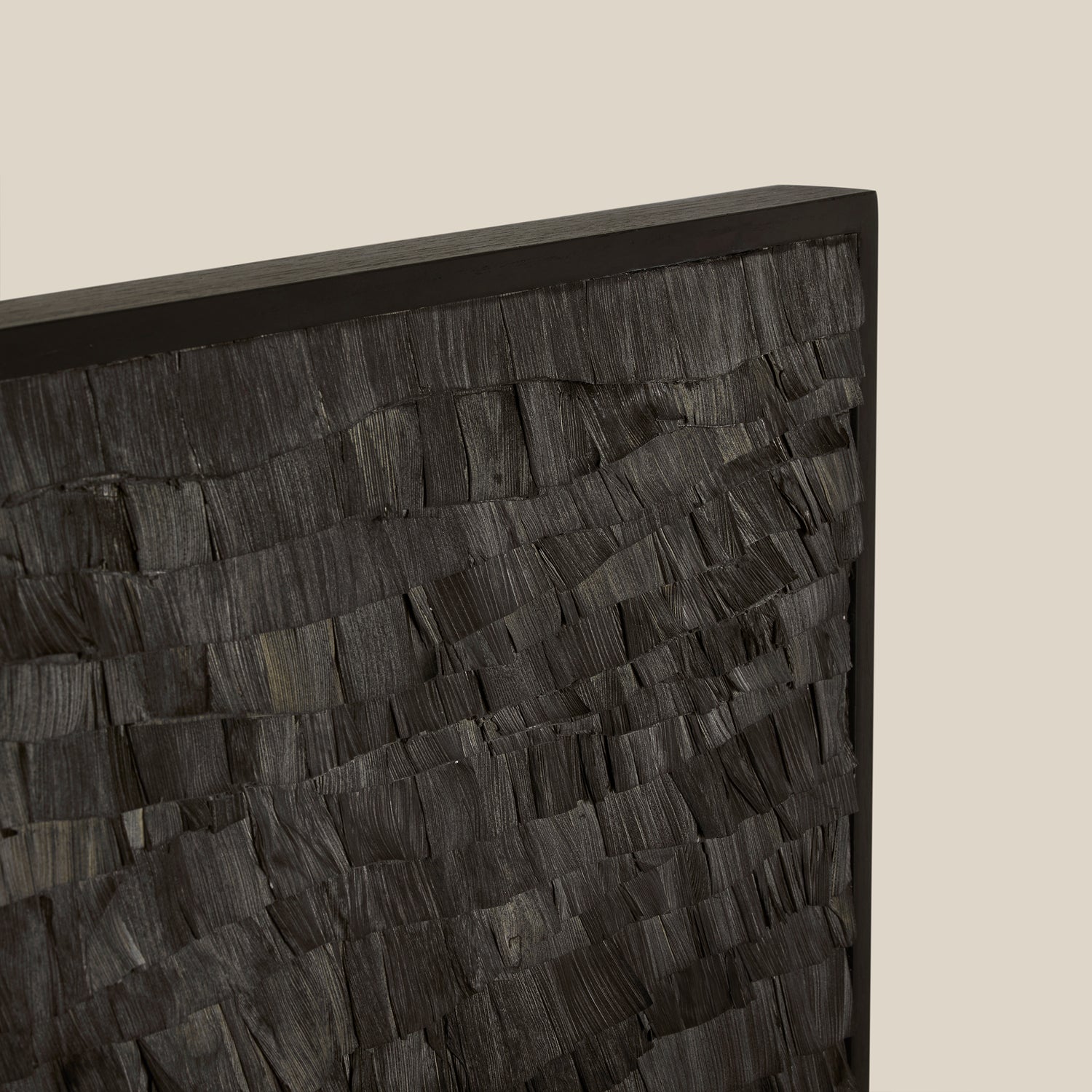 Close-up of a textured black surface with a beige background- Number 11