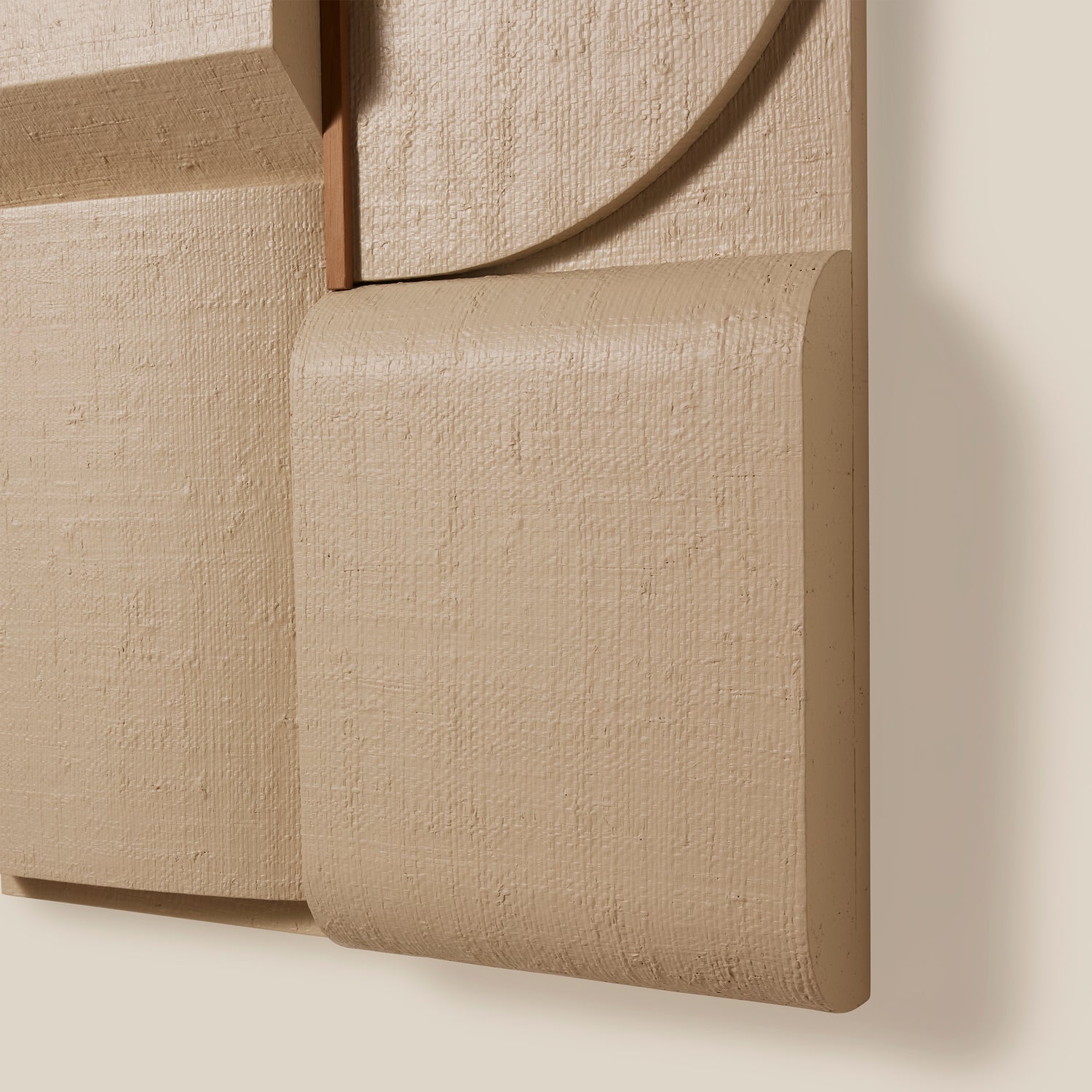 Close-up of a textured beige wall panel with a soft shadow.- Number 8