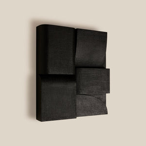 Black abstract wall sculpture on a beige background - Number 3