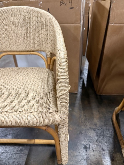 Wicker chair on a concrete floor with cardboard boxes in the background- Number 3