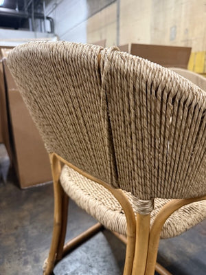 Wicker chair with a blurred background of cardboard boxes and a concrete floor. - Number 4