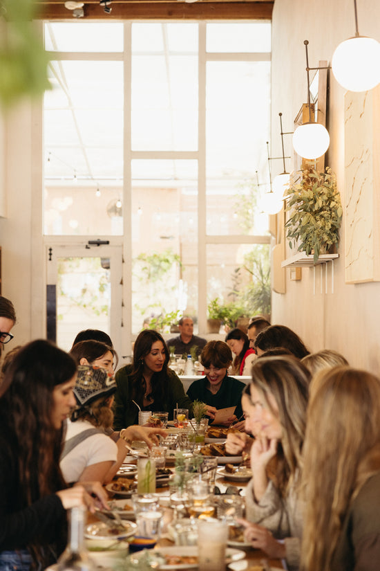 Group of people dining together in a bright, modern restaurant.