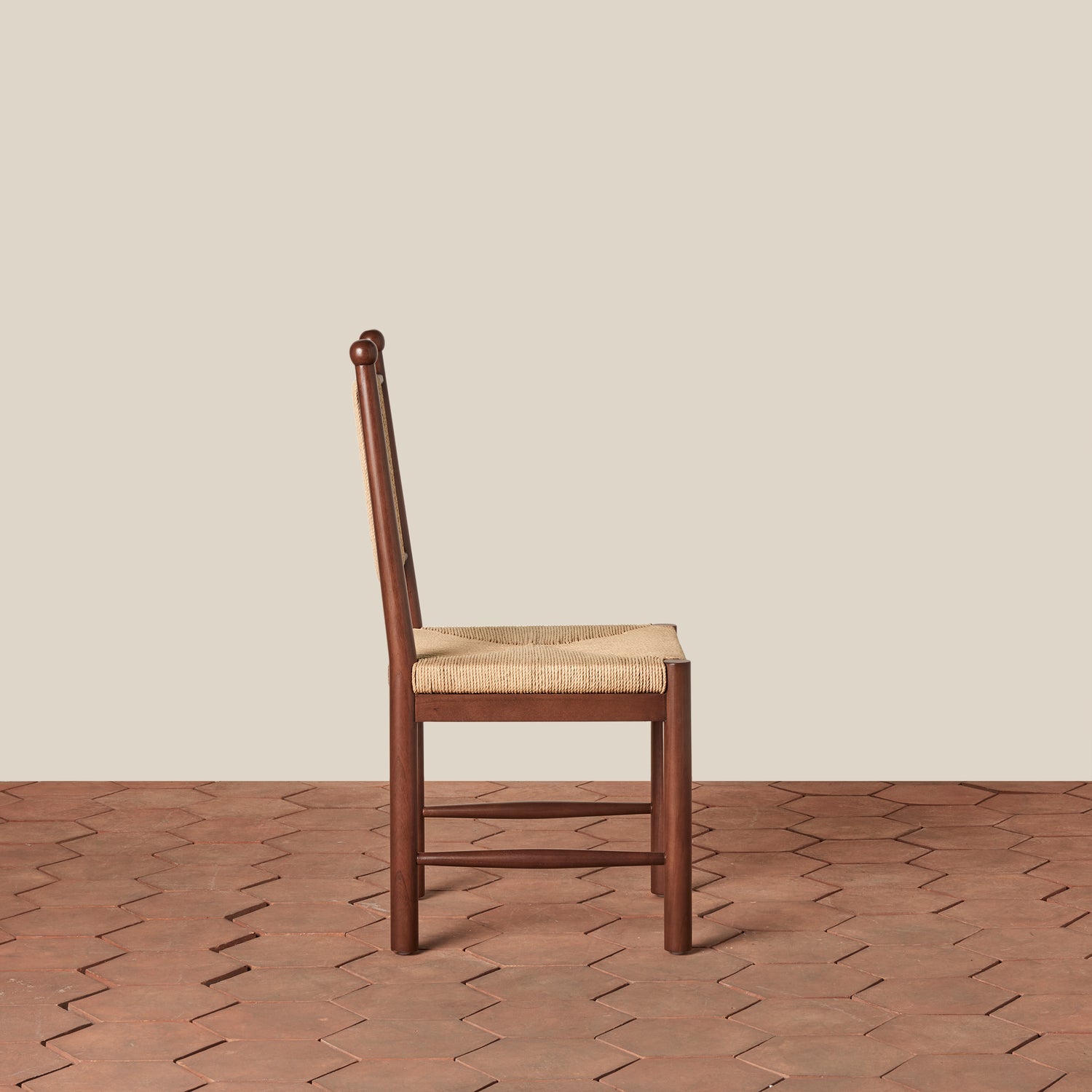 Wooden chair with a woven seat on a wooden floor and beige wall background- Number 4