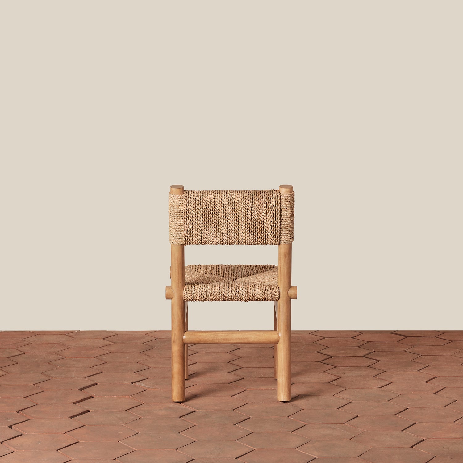 Wooden chair with woven backrest on a wooden floor and beige wall- Number 7