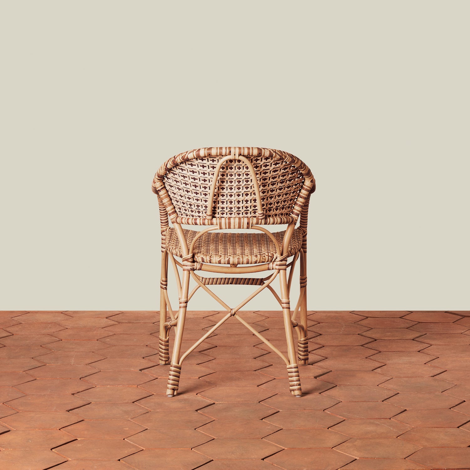 beige woven chair on tile floor with neutral background- Number 8