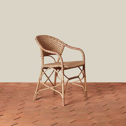beige woven chair on tile floor with neutral background