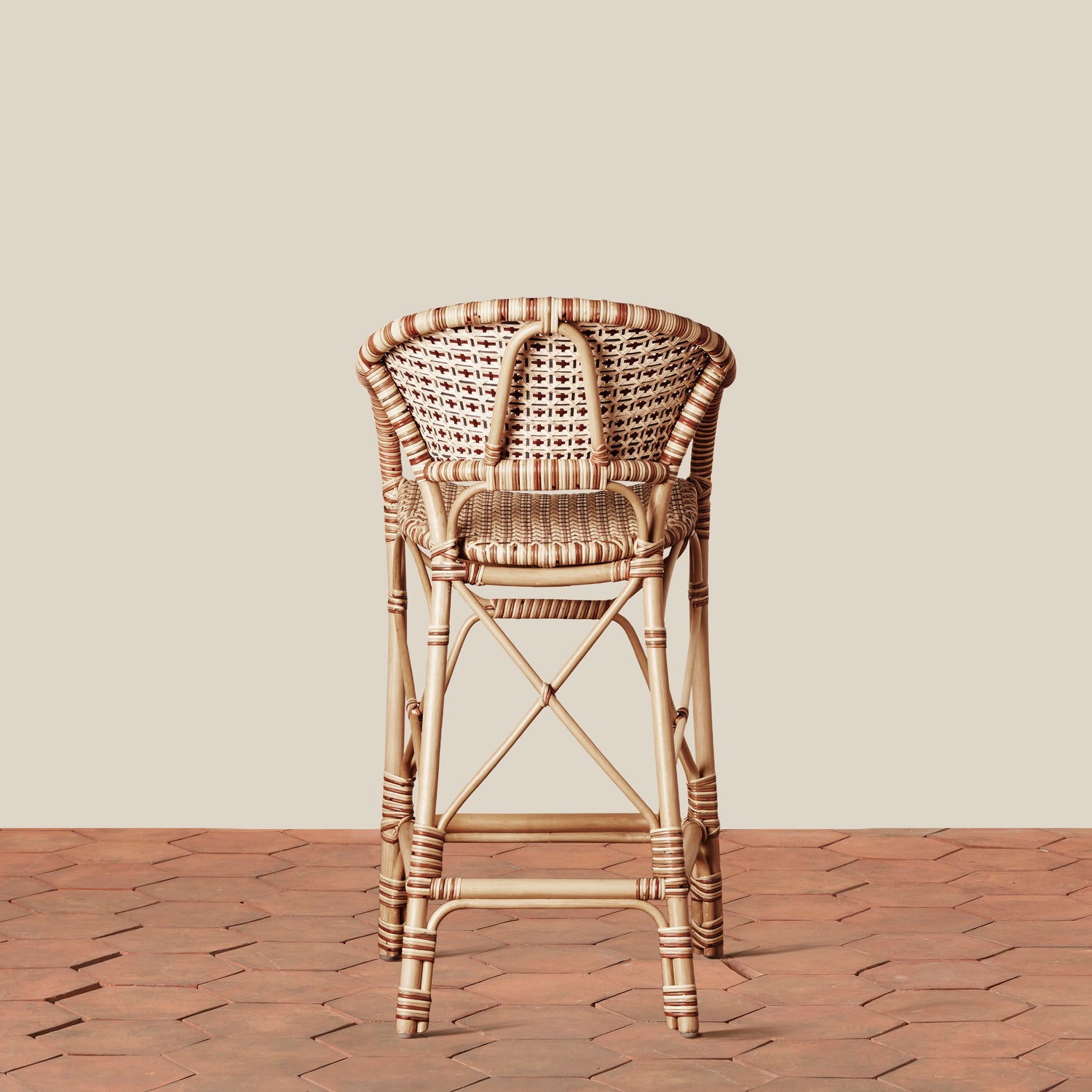back of beige woven counter stool on tile floor with neutral background- Number 4