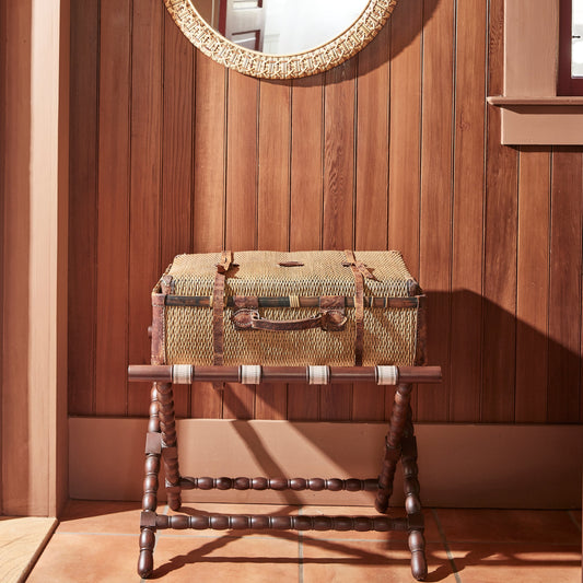brown luggage rack with luggage on top, against wooden wall - Image 2