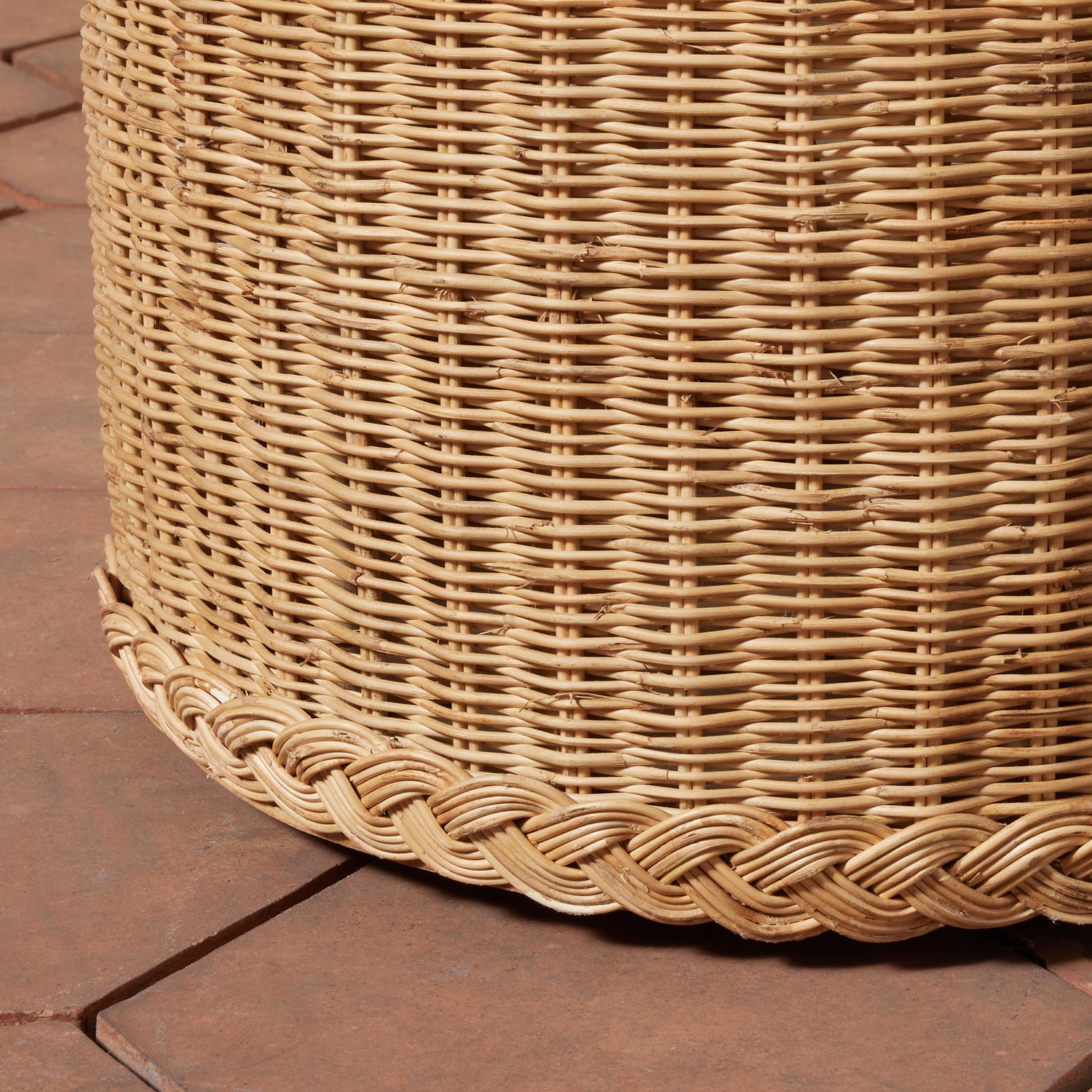 Close-up of a woven wicker basket on a wooden floor.- Number 3