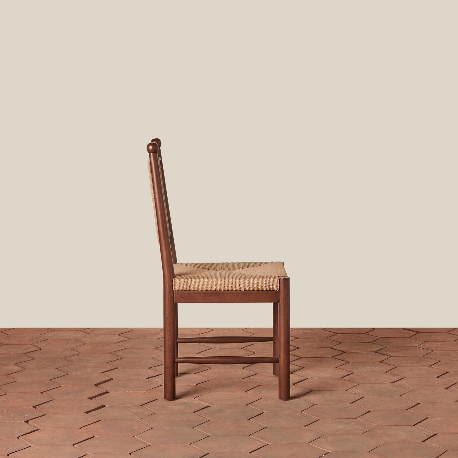 Wooden chair with a woven seat on a wooden floor and beige wall background- Number 4