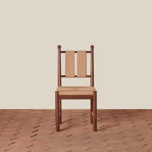 Wooden chair with woven backrest on a wooden floor and beige wall background - Number 5