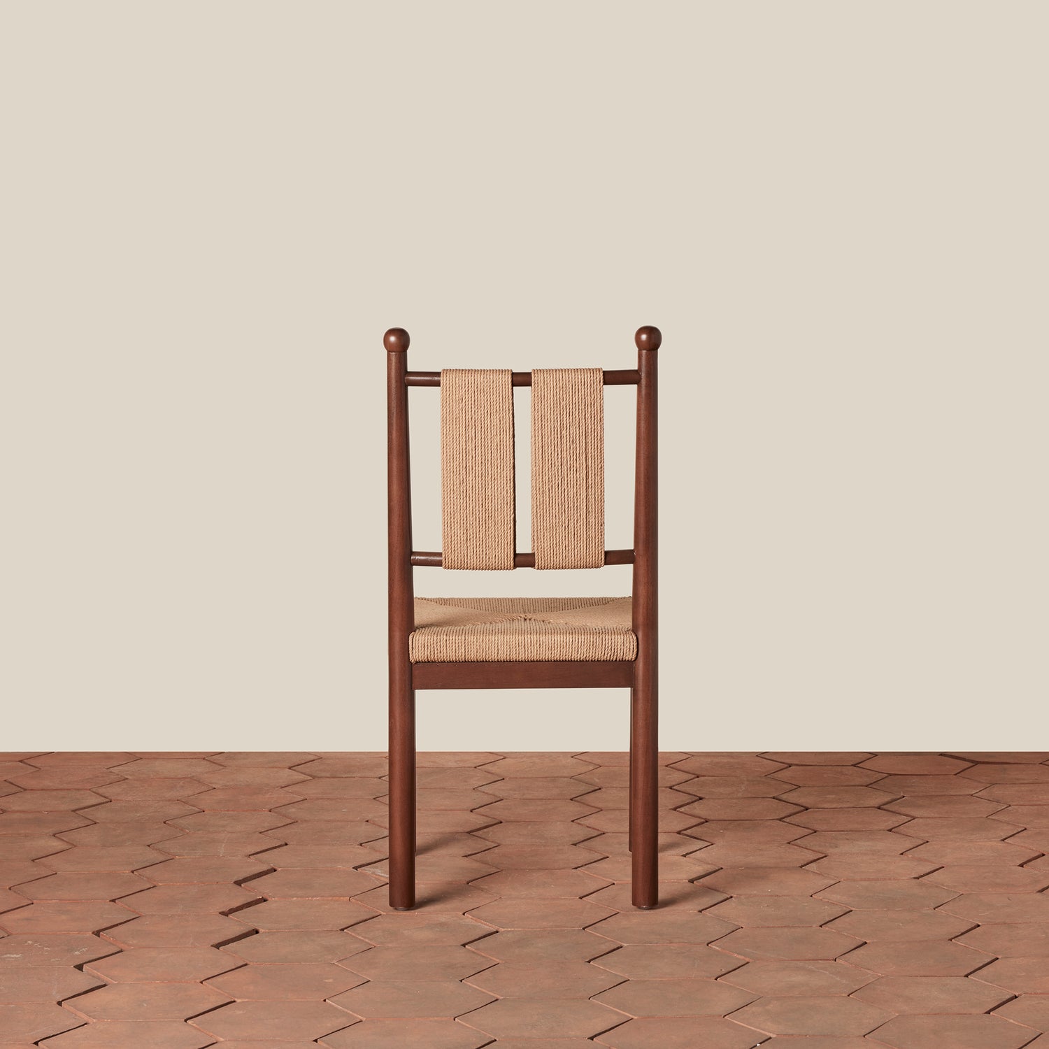 Wooden chair with woven backrest and seat on a wooden floor and beige wall background- Number 6