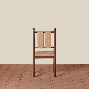 Wooden chair with woven backrest and seat on a wooden floor and beige wall background - Number 6