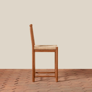 Wooden bar stool with woven seat on a wooden floor and beige wall background - Number 8