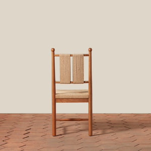 Wooden chair with woven backrest on a wooden floor and beige wall - Number 12