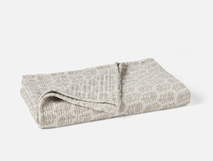 Folded textured blanket on a white background - Number 1