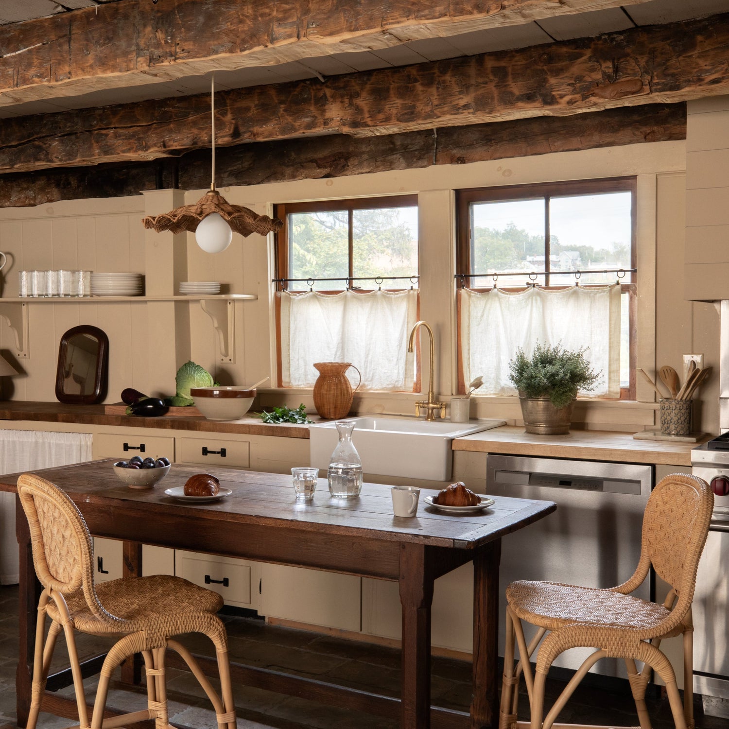 Cozy kitchen with wooden table and chairs, rustic beams, and natural light.- Number 2