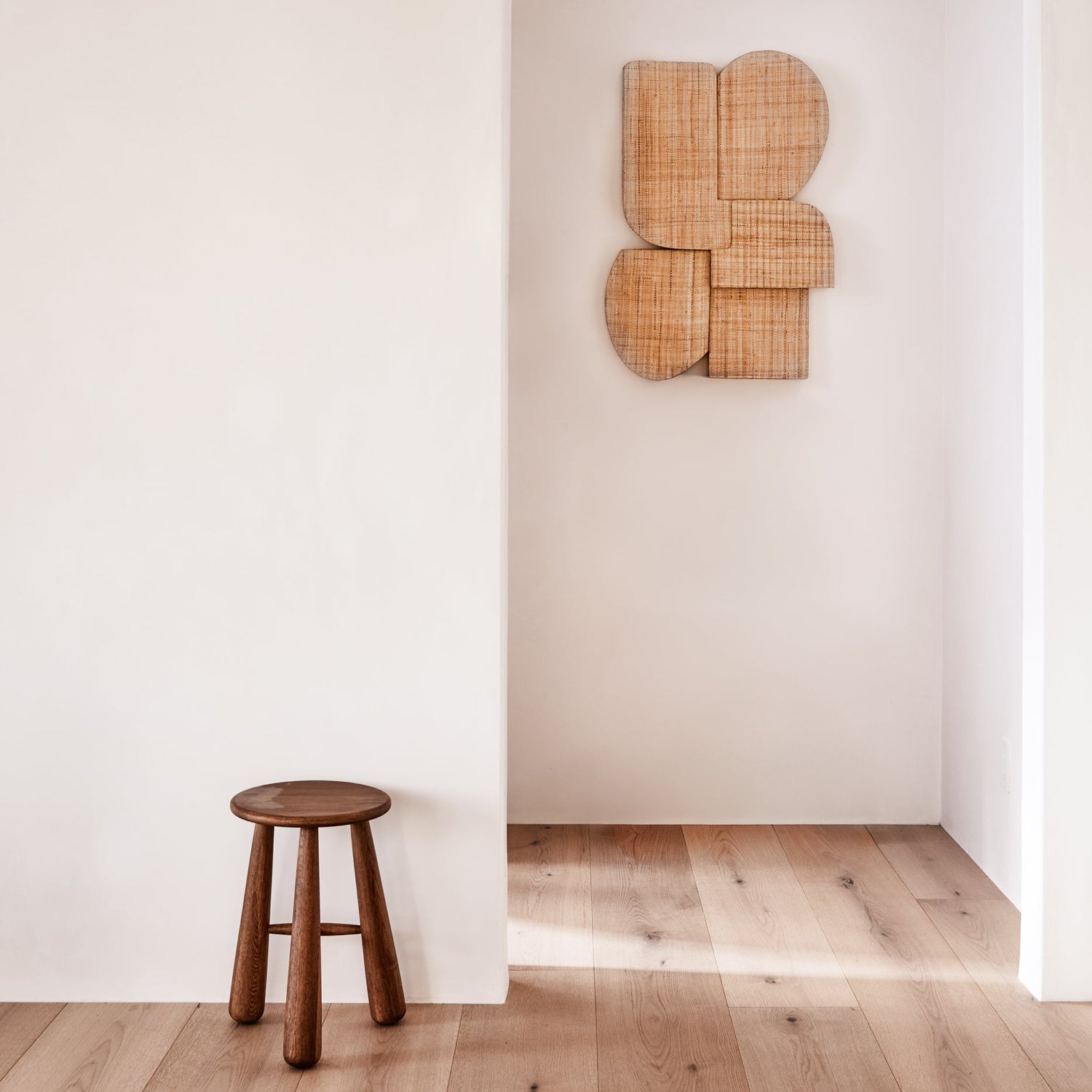 brown wall hanging against white background with brown stool on wooden floor - Number 2