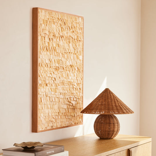 beige rectangular artwork hanging against neutral background with lamp and books on table - Image 2
