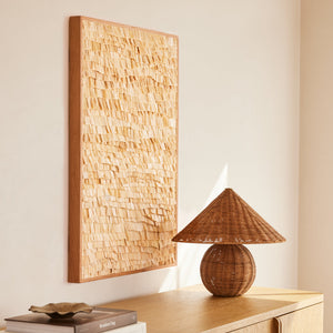 beige rectangular artwork hanging against neutral background with lamp and books on table - Number 2