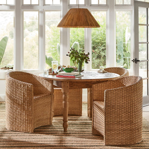 3 large chairs around circular table with pendant light hanging above, against white windows  - Number 2