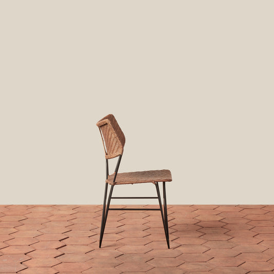 Wooden chair with woven backrest on a wooden floor and beige wall - Image 2