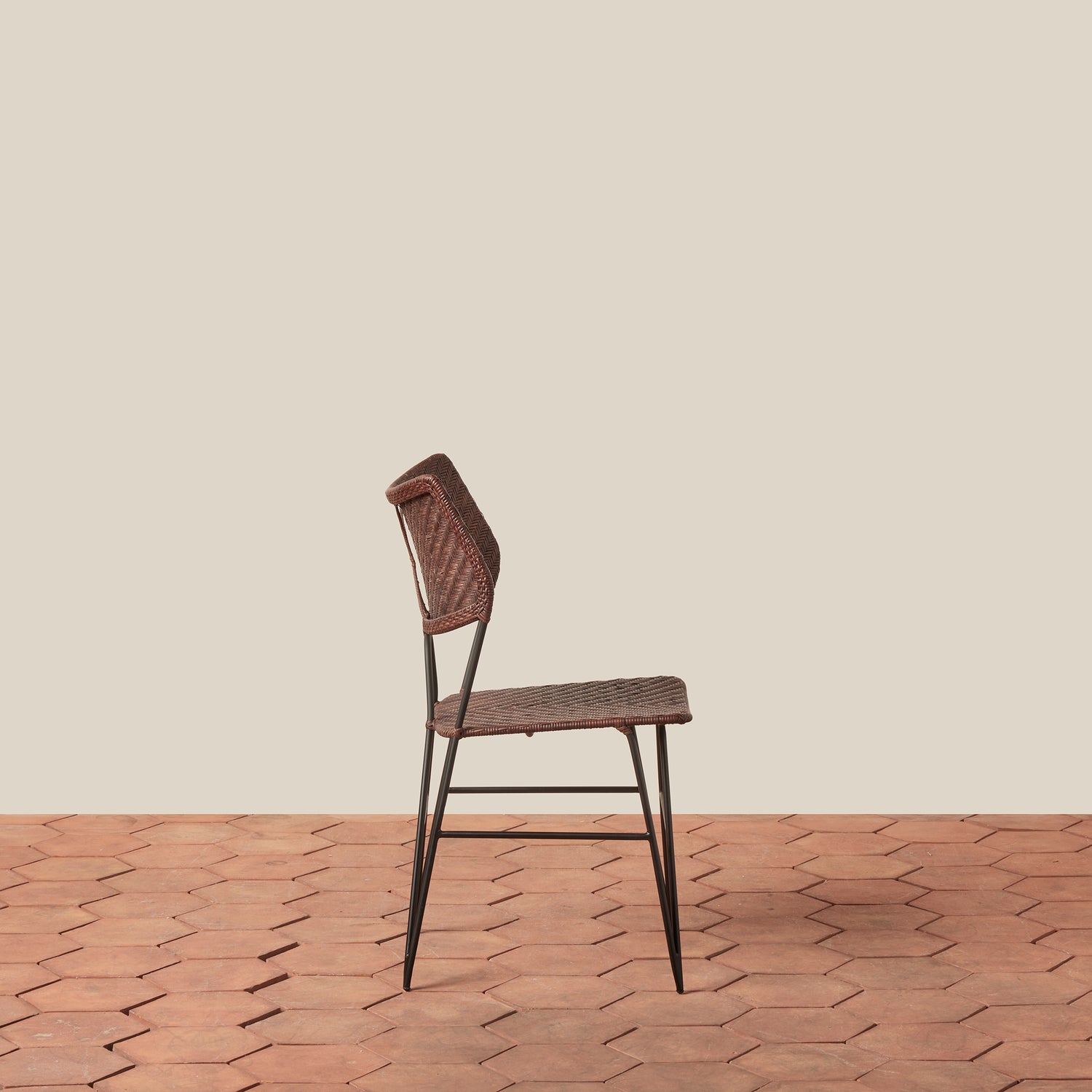 Brown chair on a wooden floor with a beige wall background- Number 8