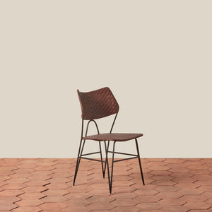 Woven chair on a wooden floor with a beige wall background - Number 7